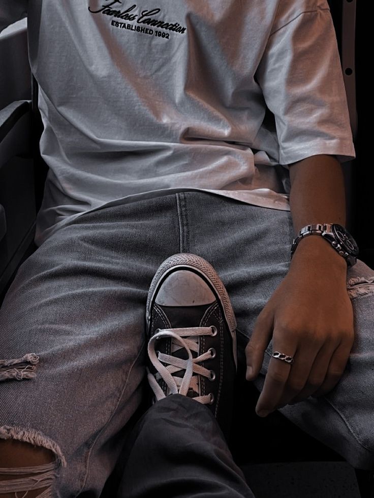 a person sitting on an airplane with their feet crossed