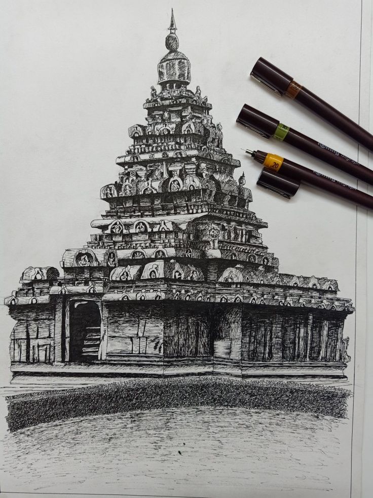 pencils and markers are laying on top of a drawing of a temple in india