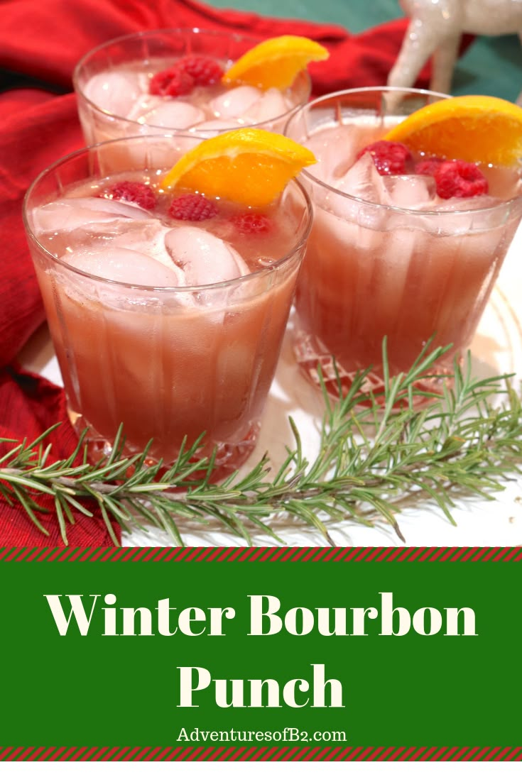 winter bourbon punch with oranges and rosemary garnish