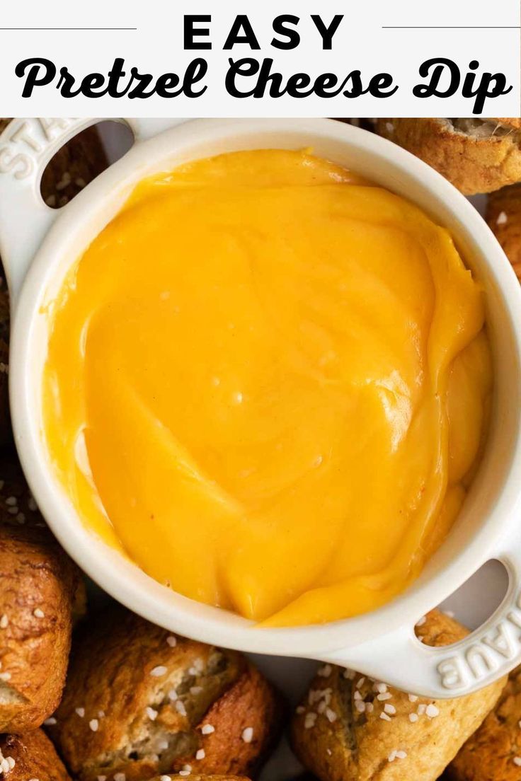 cheese dip in a white bowl surrounded by croissants