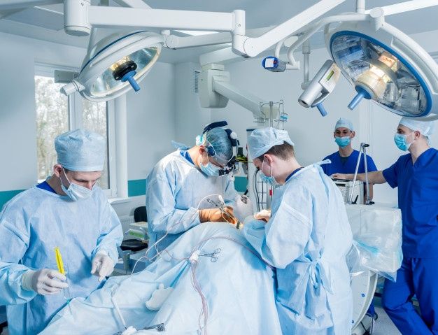 doctors and nurses performing surgery in an operating room