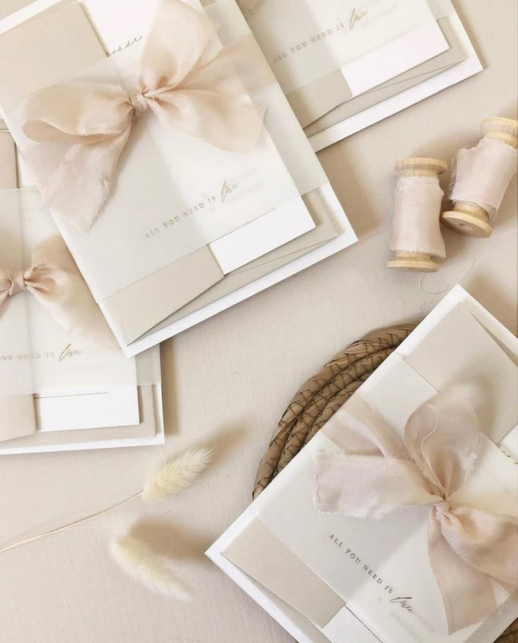 the wedding stationery is laid out with ribbon and twine