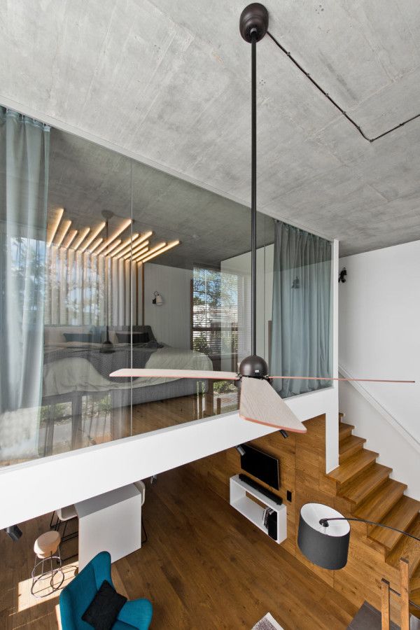 the interior of a modern house with wood floors and glass railings on the second floor