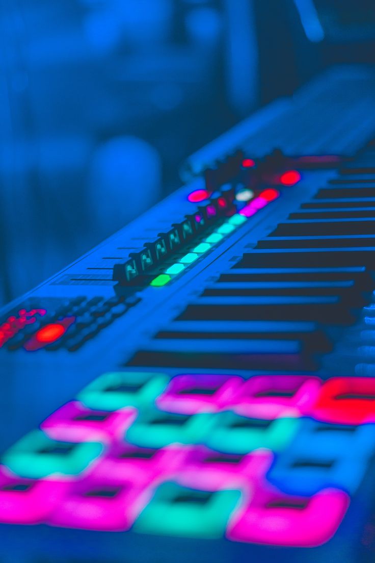 an electronic mixing board with colorful lights on it