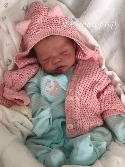 a newborn baby is wearing a pink knitted hat