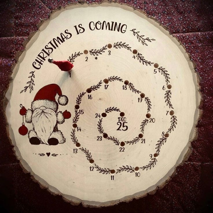 a wooden clock decorated with santa claus's is coming