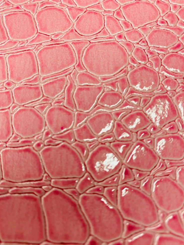 the texture of an alligator skin pattern is shown in this close up photo, with pink hue