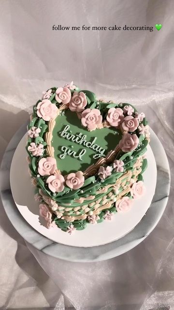 a heart shaped cake with flowers on it