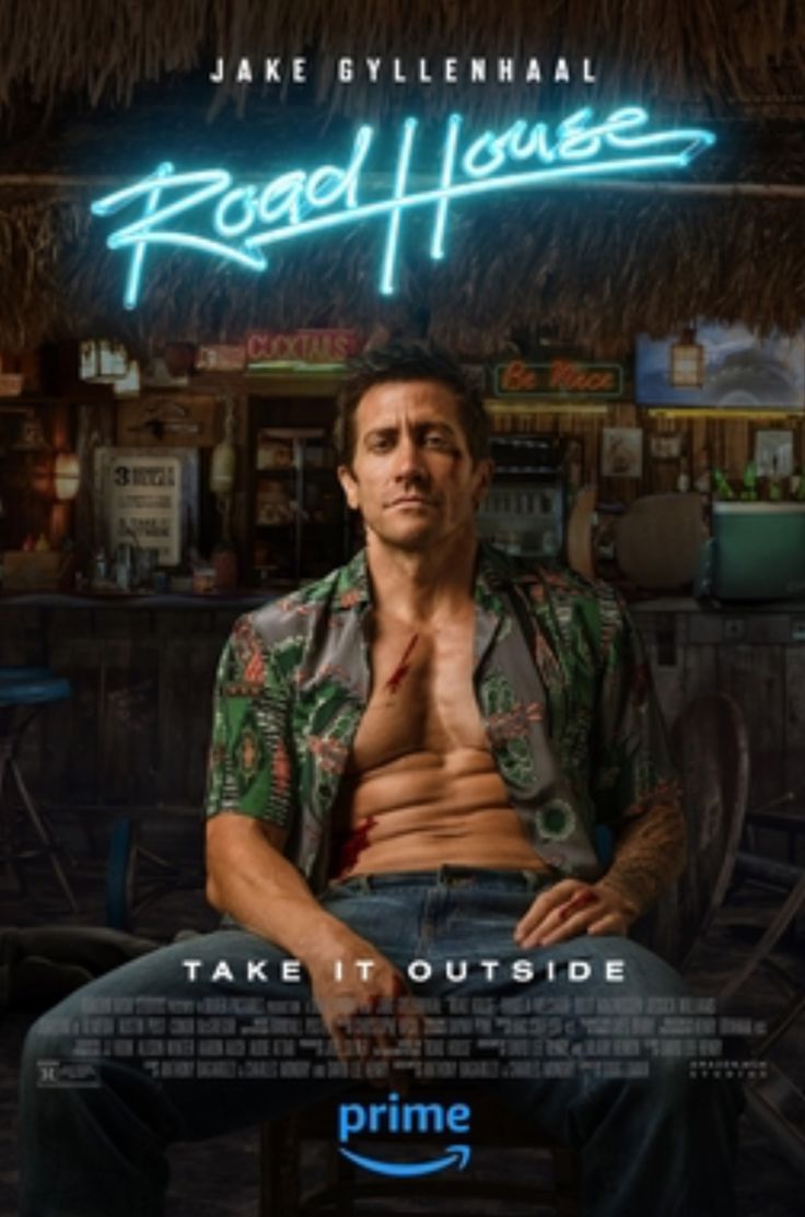 a man sitting on top of a chair in front of a sign that says road house