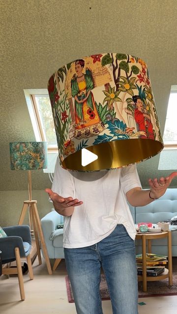 a woman standing in a living room with a lamp on top of her head and hands out