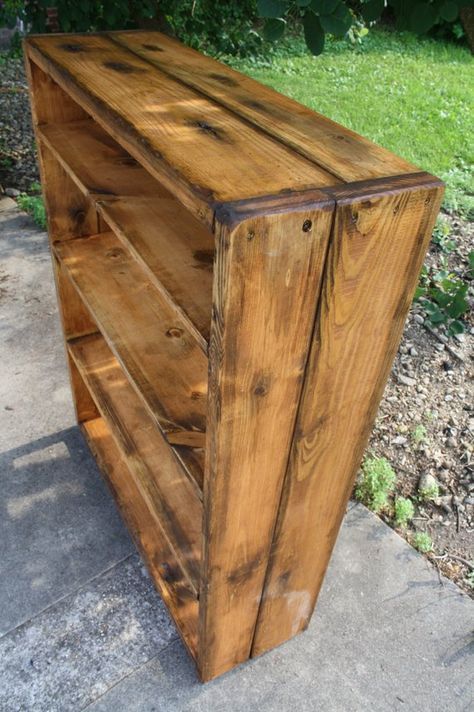 a wooden cabinet sitting on top of a sidewalk