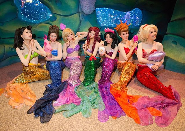 there are many mermaids that are sitting on the floor in front of each other