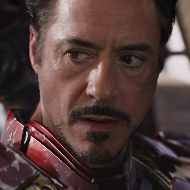 the iron man is staring at something in front of him with an intense look on his face