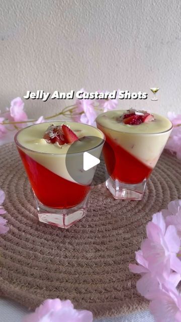 two desserts are sitting on a mat with pink flowers in the background and text that reads jelly and crystal shots