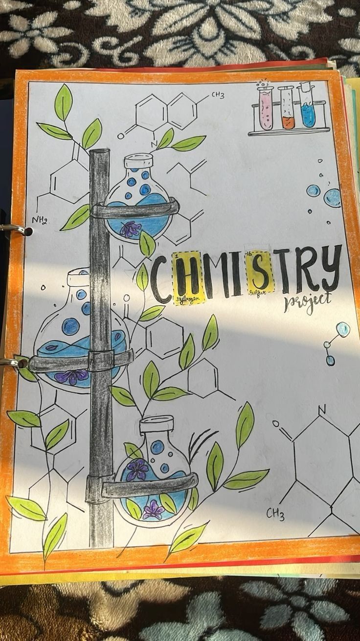 an open book with drawings on it sitting on a table next to a plant and microscopes