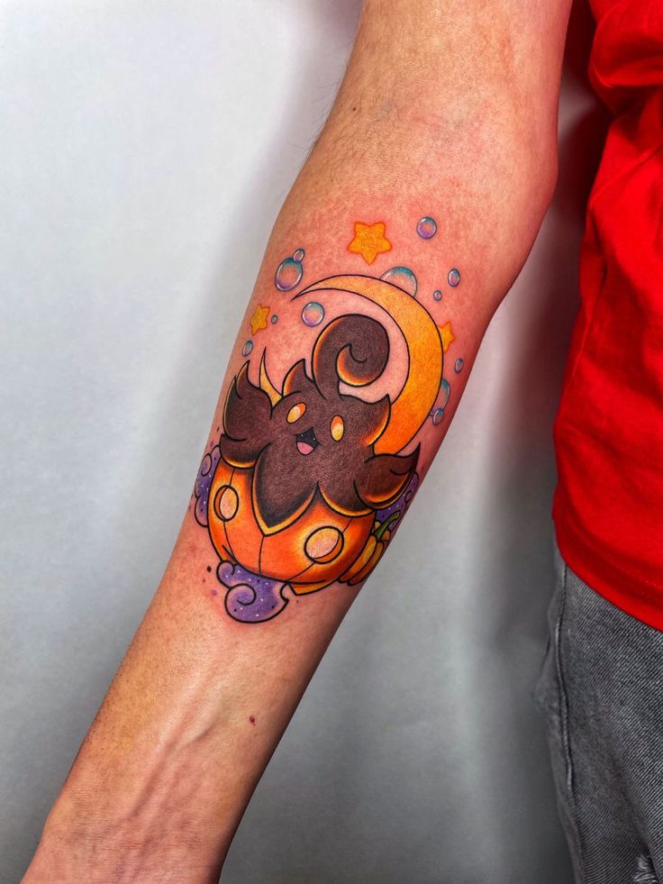 a person with a tattoo on their arm holding an orange and black cat in the moon