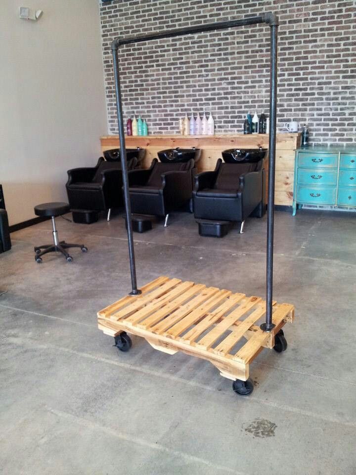 a wooden pallet sitting in the middle of a room filled with hair salon chairs