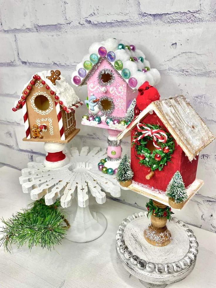 three bird houses are sitting on top of each other in front of a brick wall