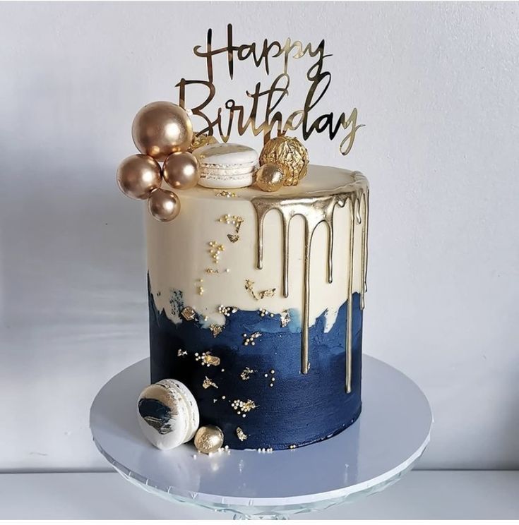 a birthday cake decorated with gold and blue icing