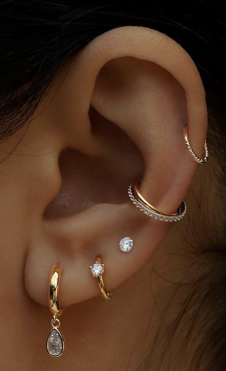 three different types of ear piercings on top of each other