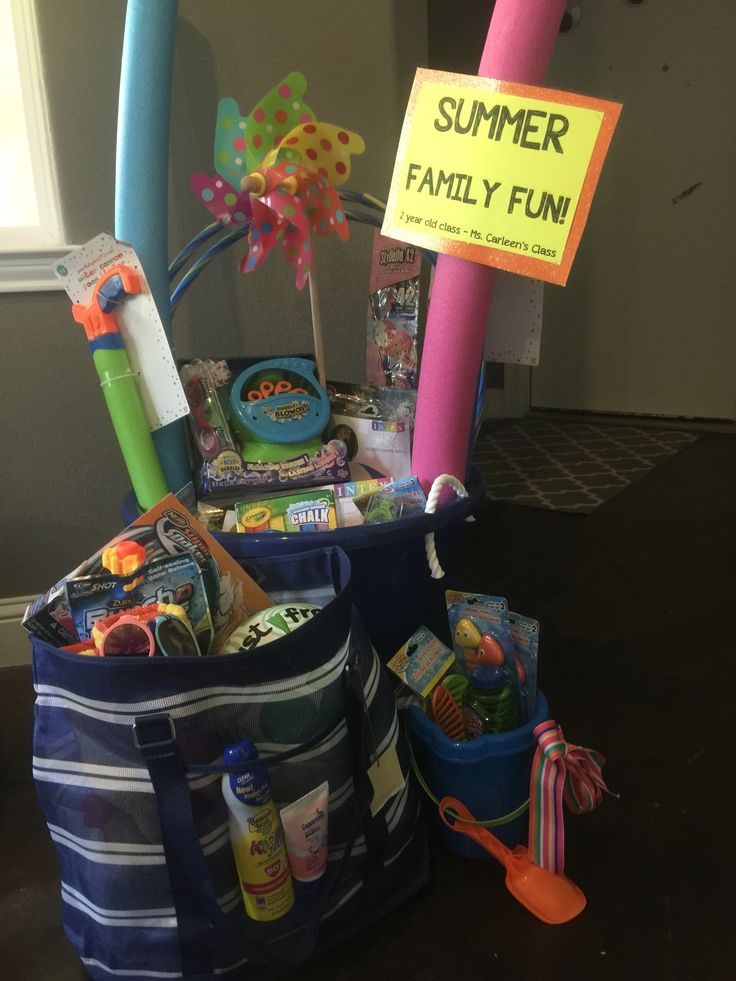 a bag filled with toys sitting on top of a table next to a sign that says summer family fun