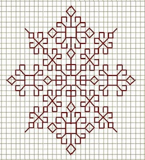 a cross stitched snowflake is shown in black and white, with red accents