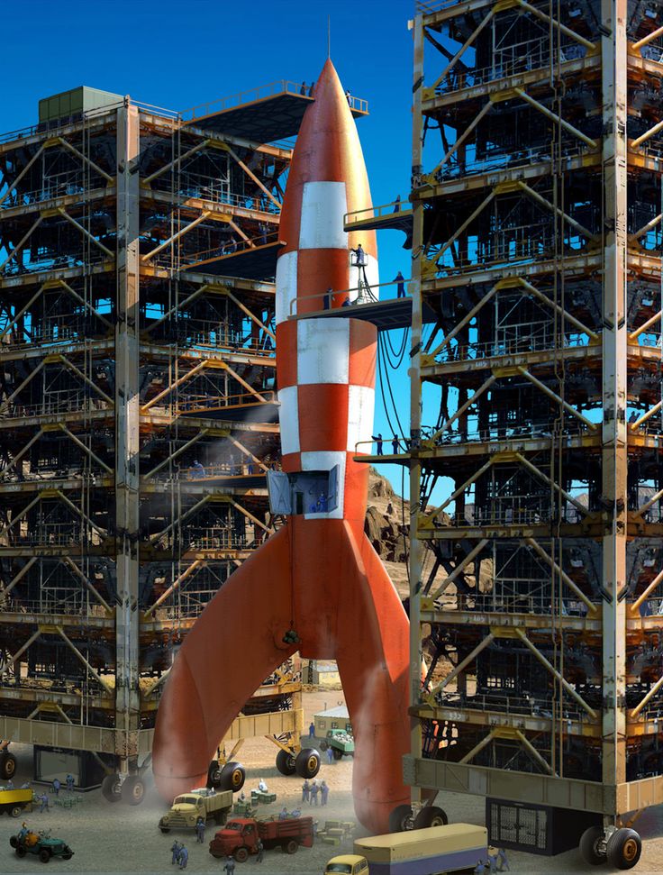 an orange and white rocket is on display in front of some scaffoldings