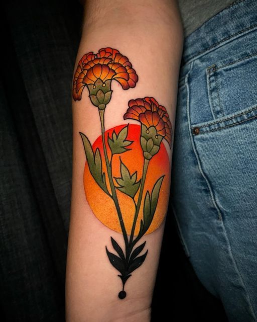 a woman's arm with flowers on it and an orange sun behind the flower