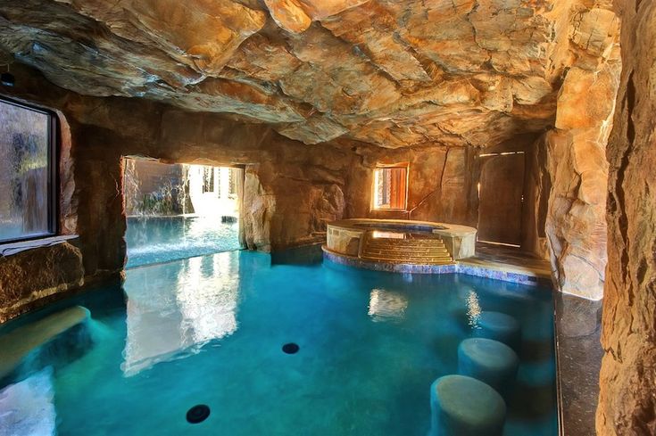 an indoor swimming pool in the middle of a cave