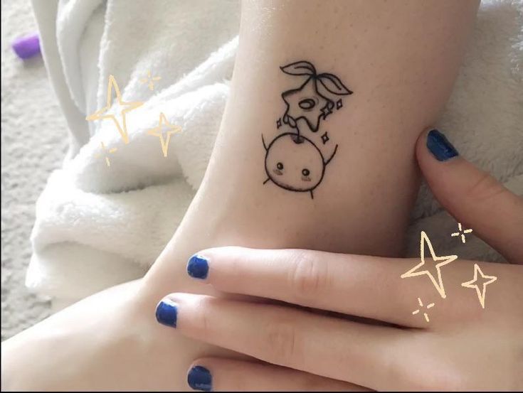 two people with matching tattoos on their feet, one has a rabbit and the other has stars