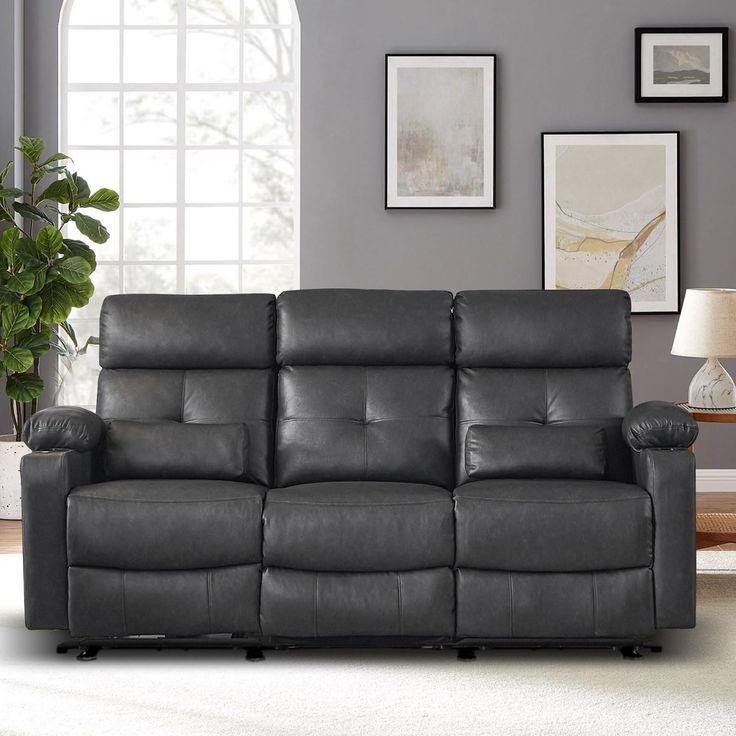 a gray leather reclining sofa in a living room