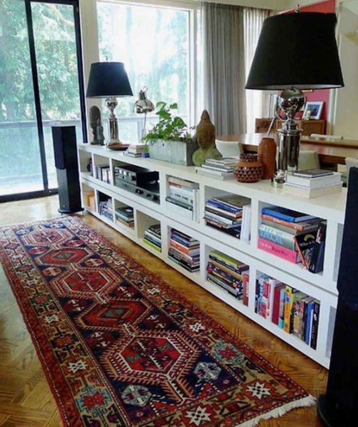 a living room filled with furniture and a large rug