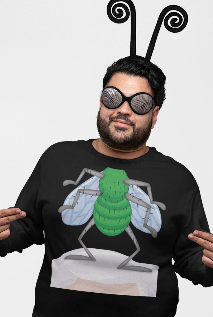 a man with sunglasses on his head wearing a bee shirt and standing in front of a white background