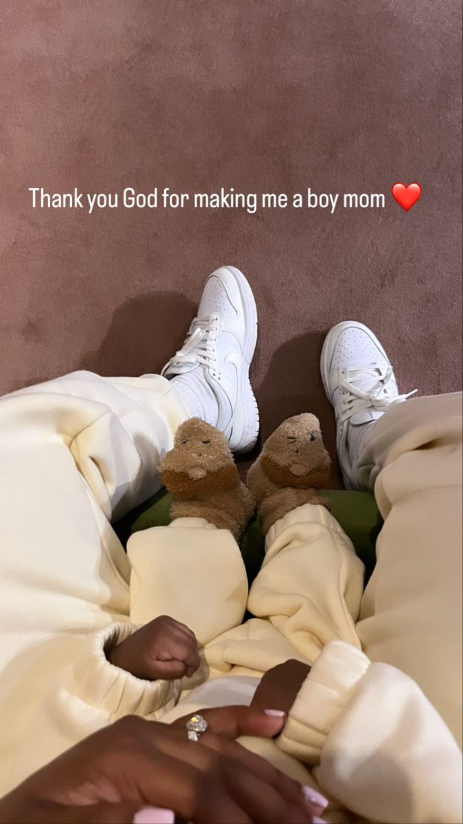 a person laying in bed with their feet up on the pillow and two teddy bears