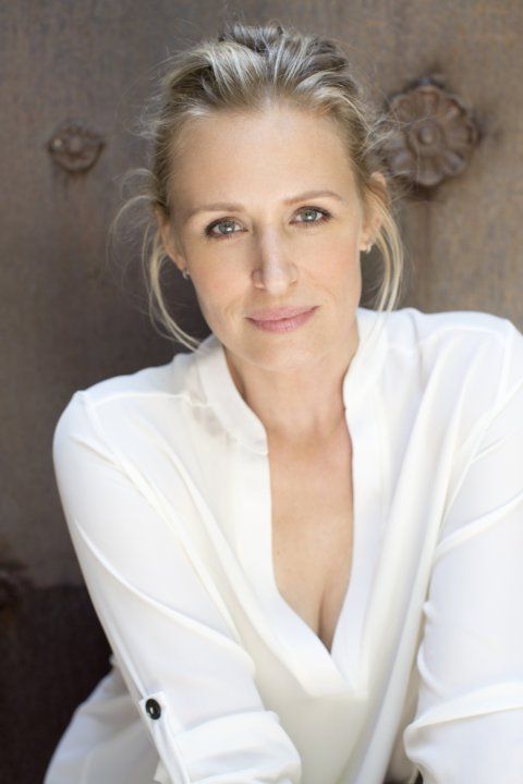 a woman in white shirt posing for a photo