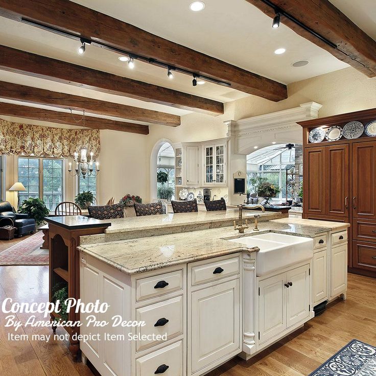 a large kitchen with white cabinets and an island in the middle of the room is shown