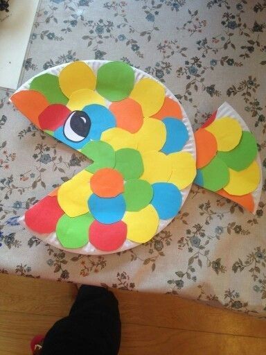 a paper plate shaped like a fish on a table