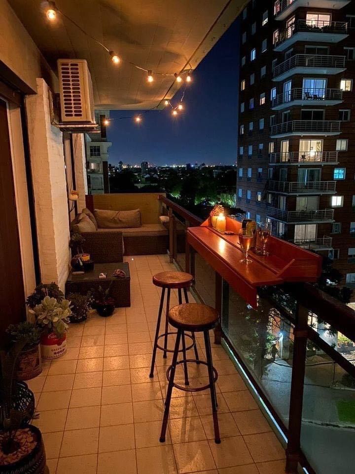 an apartment balcony at night with lights on