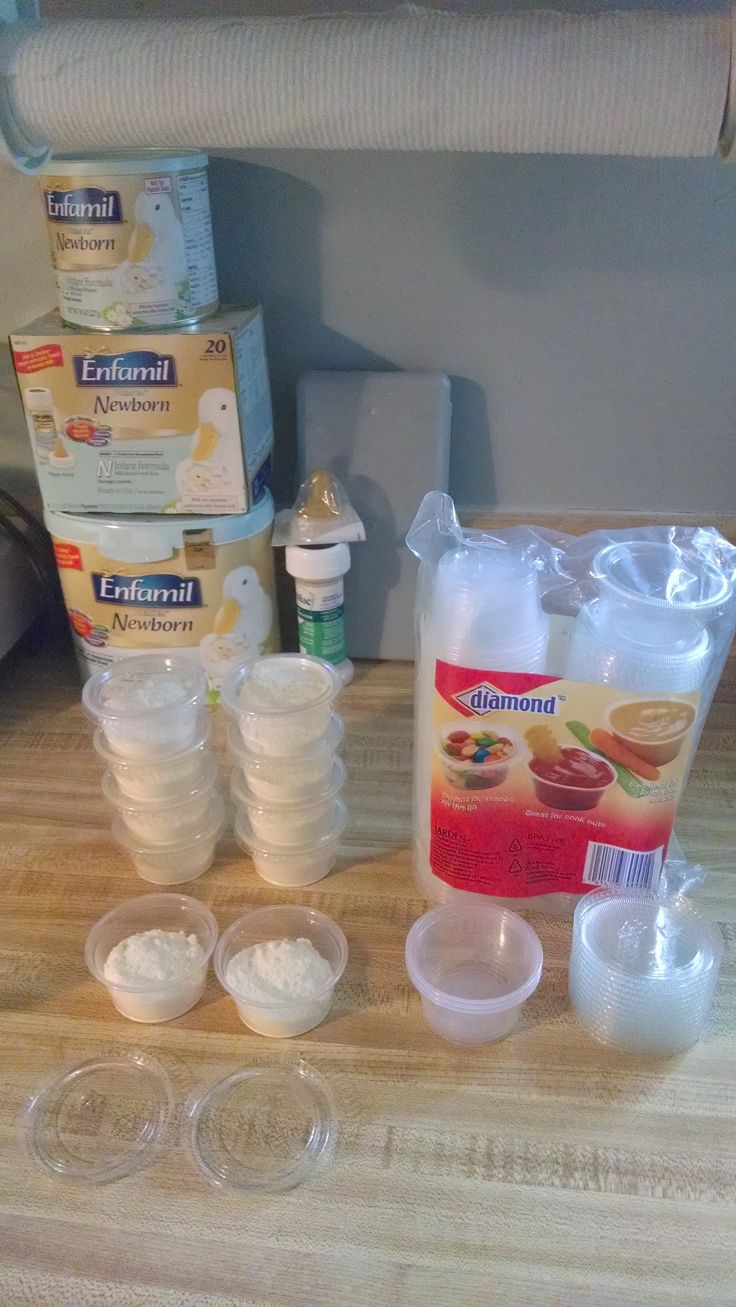 the contents of a diaper sit on a table next to several empty cups and containers