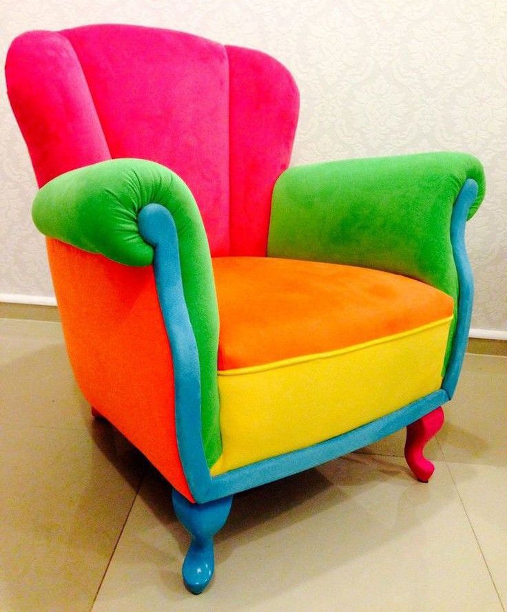 a brightly colored chair sitting on top of a tile floor