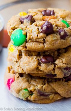 soft - baked monster cookies stacked on top of each other