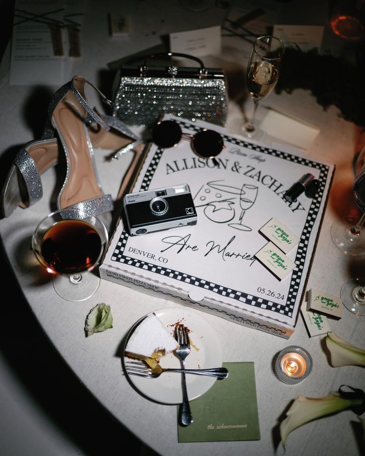 the table is set up for an event with high heel shoes and other items on it