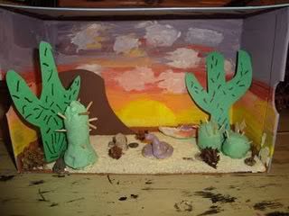 some fake cactus plants sitting on top of a table