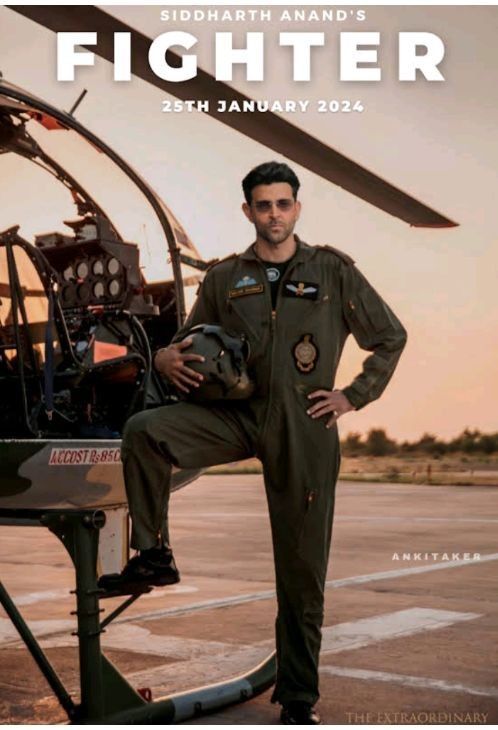 a man standing in front of a helicopter with his hands on his hips while wearing an air force pilot's uniform