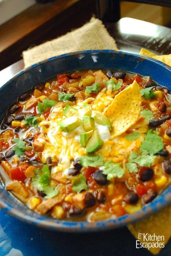 a blue bowl filled with taco soup and tortilla chips