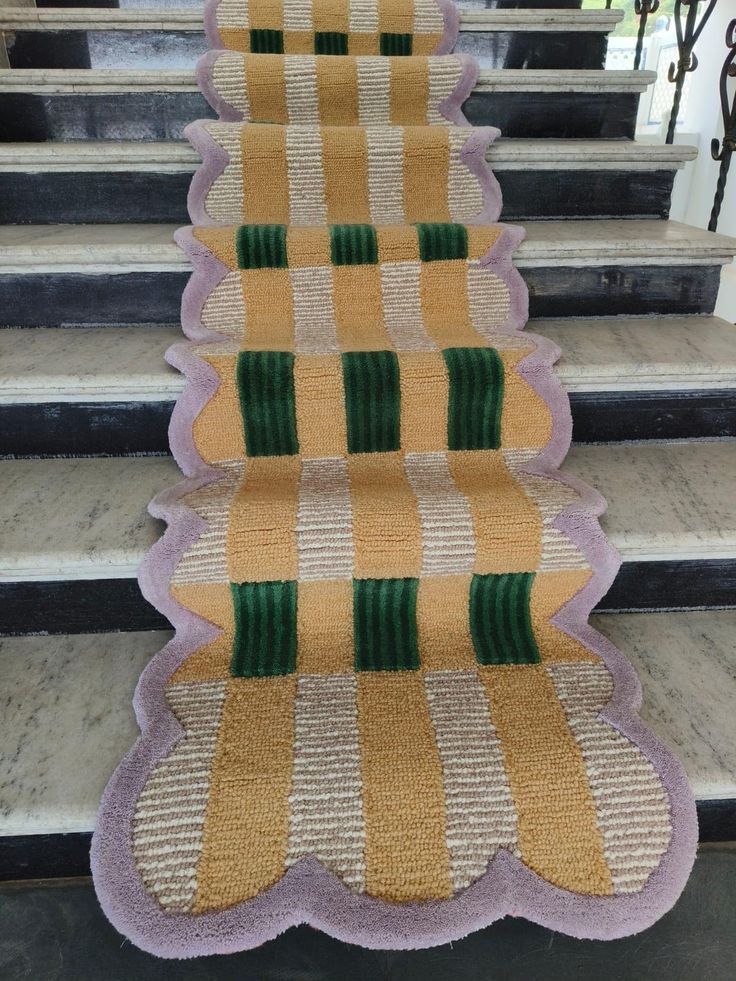 a carpeted stair tread with green and yellow stripes