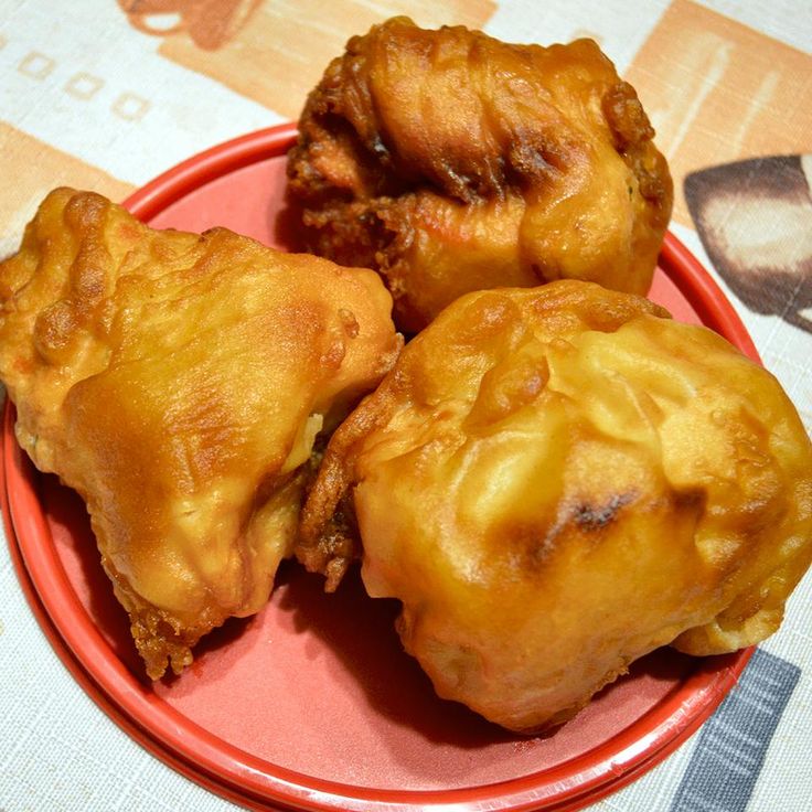 three pieces of fried food on a red plate