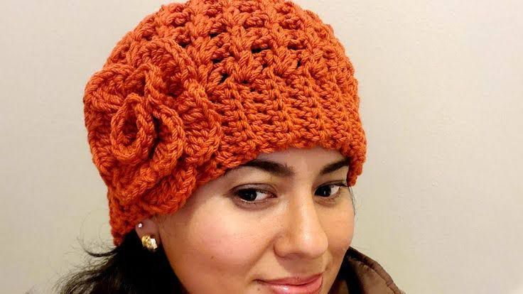 a woman wearing an orange crocheted hat