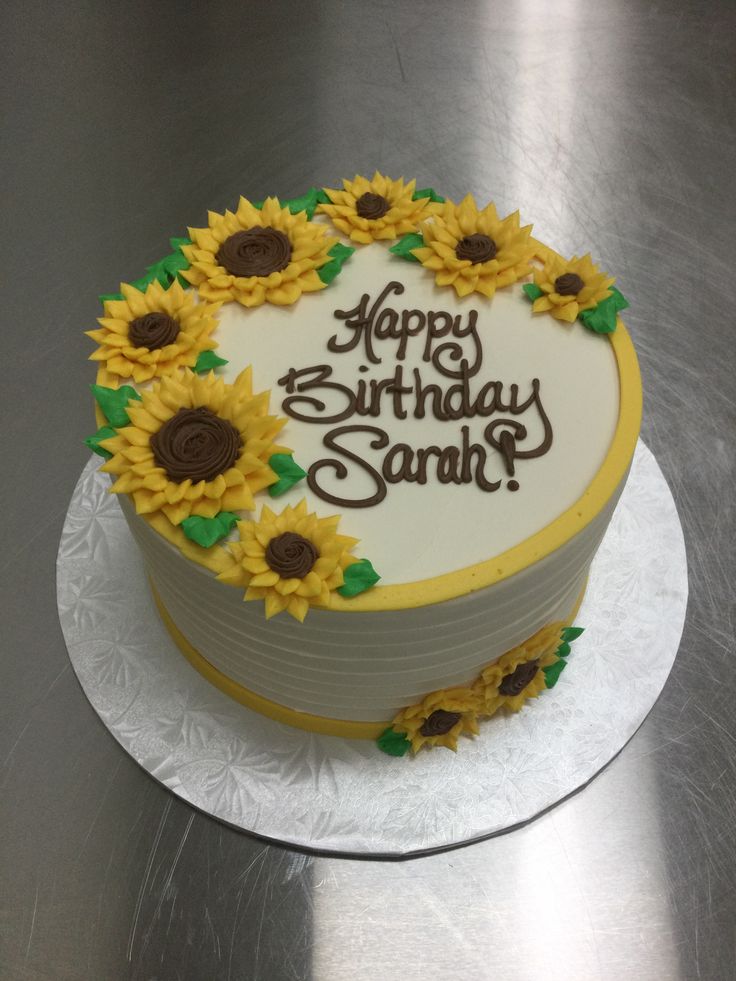 a birthday cake decorated with sunflowers and the words happy birthday sandy