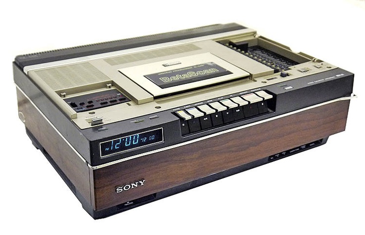 an old sony cd player sitting on top of a wooden shelf with the time displayed